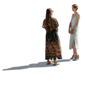 two backlit women standing