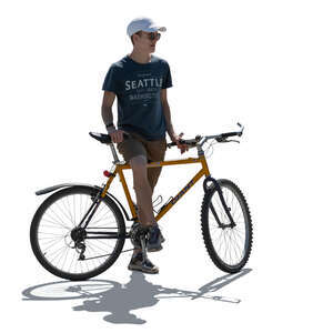 cut out backlit young man with a bike standing