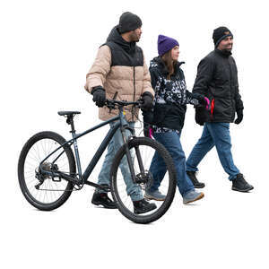 cut out group of three people with a bike walking in winter
