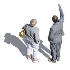 two people standing and pointing at smth seen from above