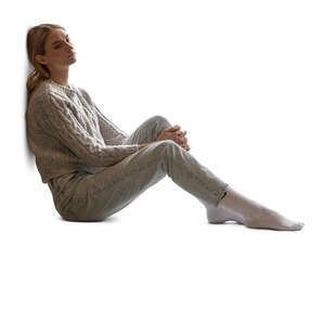 backlit woman sitting by the window