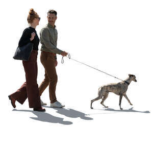 cut out backlit man and woman walking a dog