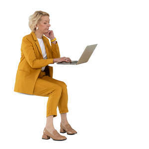 cut out woman in a yellow suit sitting and working with laptop