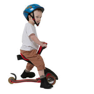 little boy riding a baby scooter