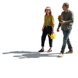 two backlit senior people going to plant flowers