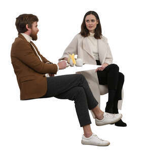 two cut out  people sitting in a coffee house