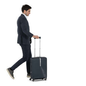man in a suit walking with a suitcase