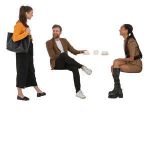 woman talking to two friends sitting in a cafe
