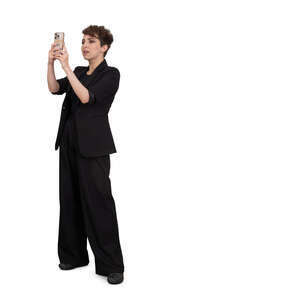 woman in a black modern suit standing and taking a picture