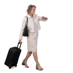 cut out grey haired older woman with a travel suitcase walking