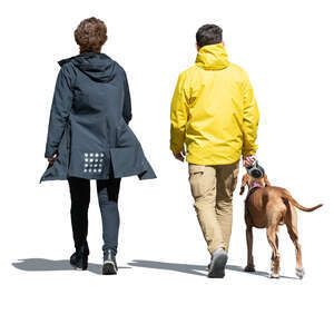 man and woman walking a dog