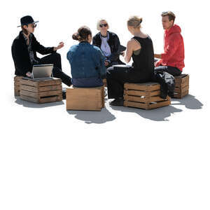 cut out backlit group of young people sitting on wooden boxes