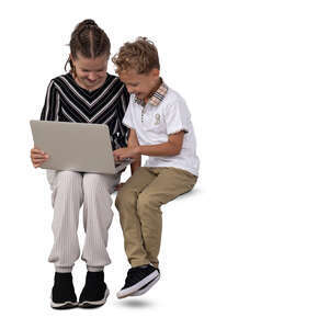 two kids sitting and holding a laptop