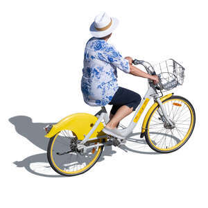 older woman with a hat riding a bike seen from above