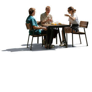 cut out backlit group of three people sitting in a cafeteria and eating