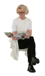 older woman sitting and reading a magazine
