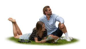 two people sitting and relaxing on the grass