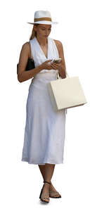cut out fancy woman in a white dress with a shopping bag standing
