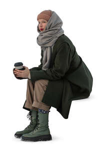 cut out woman sitting and drinking coffee on a chilly autumn day