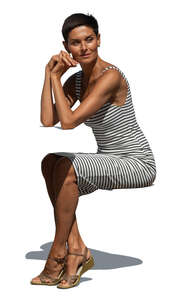 woman in a striped summer dress sitting in sunlight