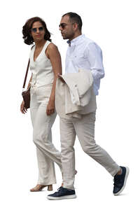 two cut out people in formal summer clothes walking