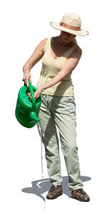 senior woman watering plants in the garden