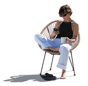 cut out backlit woman sitting in a balcony armchair