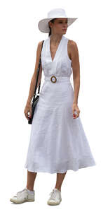 woman in a white dress and wearing a hat standing
