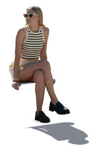 backlit young woman sitting