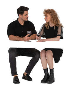 cut out couple sitting in a restaurant and drinking wine