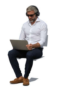 cut out man with a laptop sitting outside