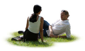 two people relaxing outside in the park on the grass