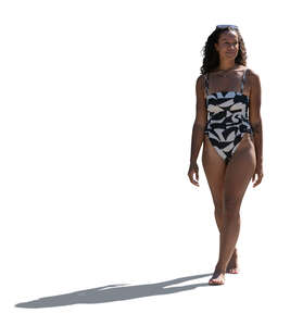 black woman in a swimsuit walking in the sunlight