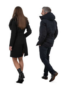 two people in dark winter outfits walking