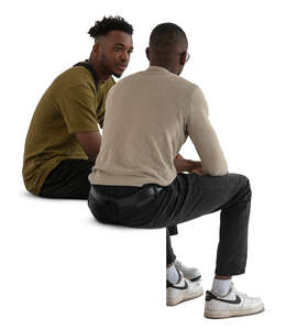 two black men sitting and talking