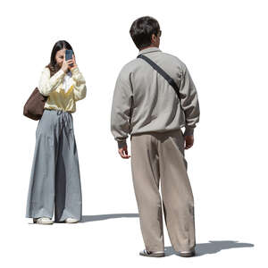 cut out asian woman taking a picture of her husband