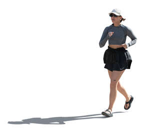 backlit woman jogging in the street