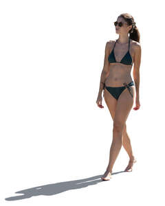 cut out backlit woman in a bathing suit walking