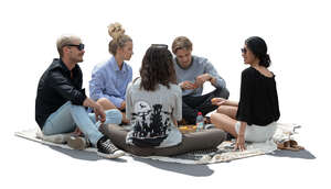 cut out backlit group of people sitting on the ground