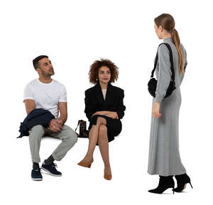 woman going over to two friend sitting on the bench