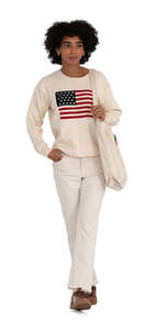 cut out black woman in a white casual outfit walking