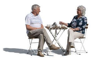 cut out elderly couple sitting in an outdoor cafe