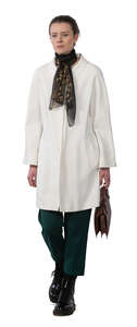 cut out woman in a white overcoat walking