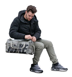 cut out young man with a sports bag sitting