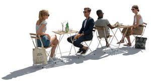 street cafe with people sitting and talking in backlight