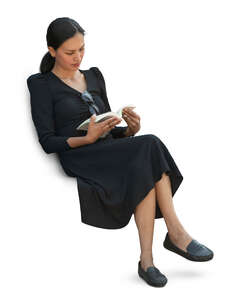 cut out woman sitting and reading seen from above