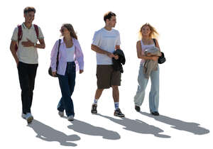 cut out backlit group of four people walking