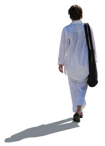 cut out woman in white in backlight walking