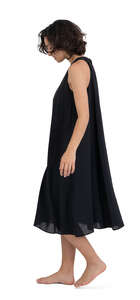 woman in a black dress and barefoot walking at home