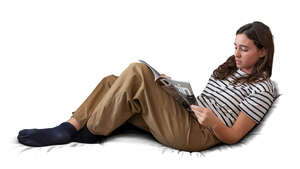 woman lying on the sofa and reading a magazine